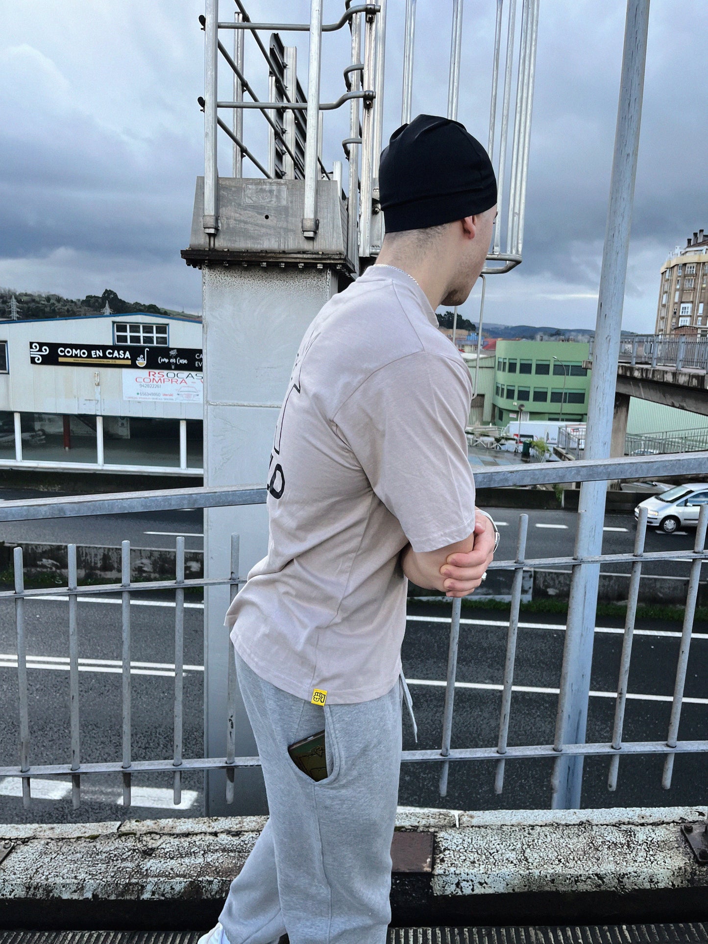 Urban guy wearing sand color t-shirt in a fashionable way.