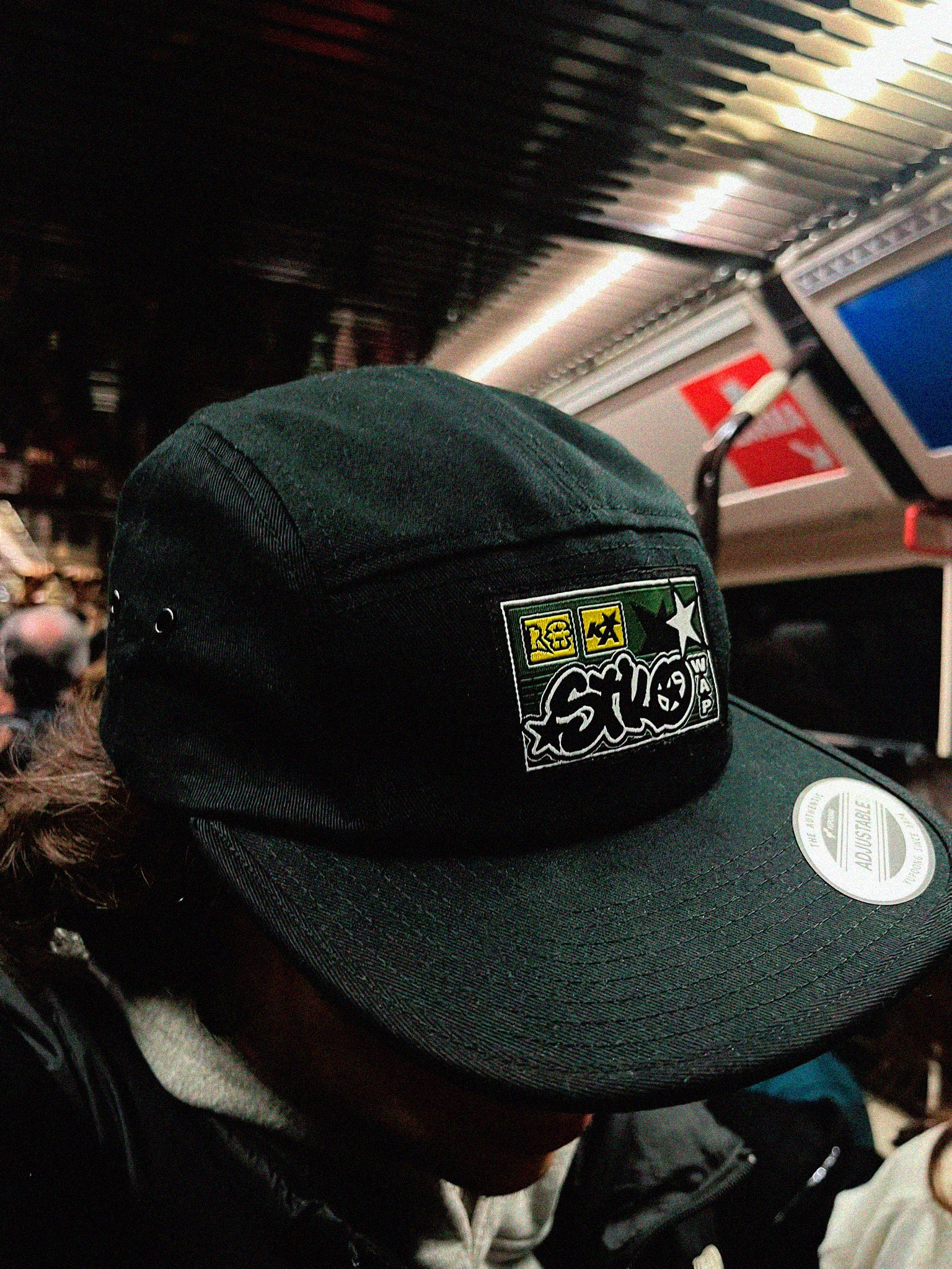 Urban guy wearing a piece of streetwear fashion, in concrete, a black hat.